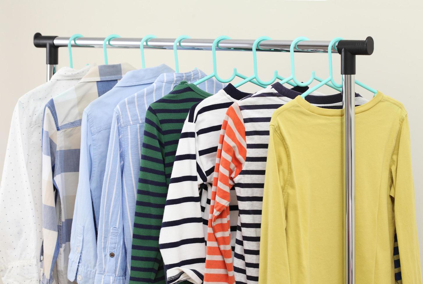 Pastel kid shirts hanging on rack photo