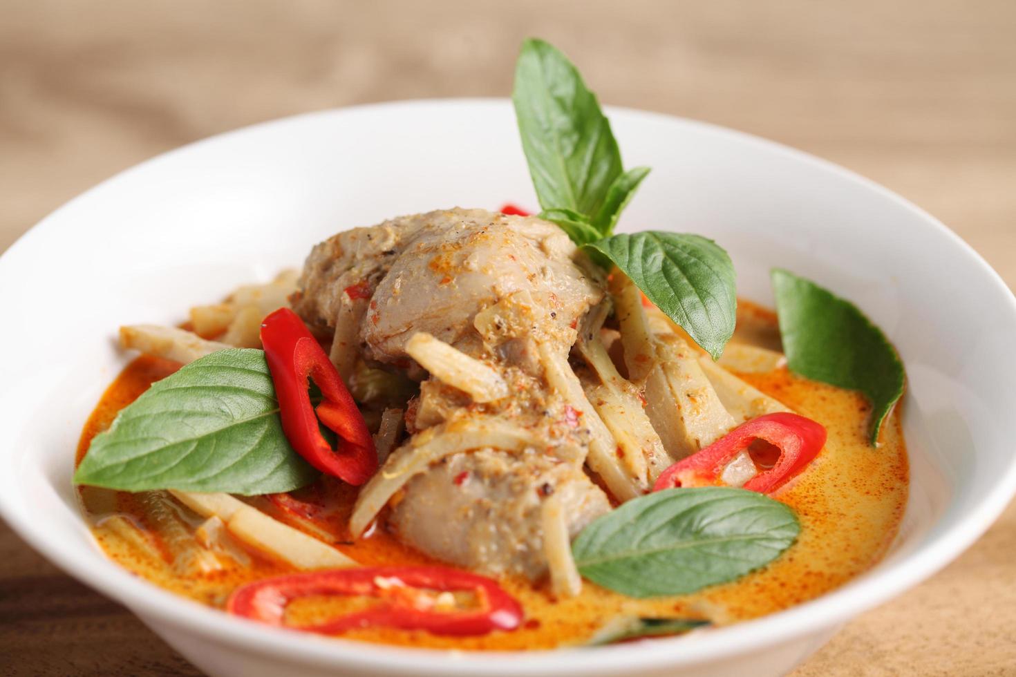 Thai chicken and bamboo shoot curry in ceramic bowl photo