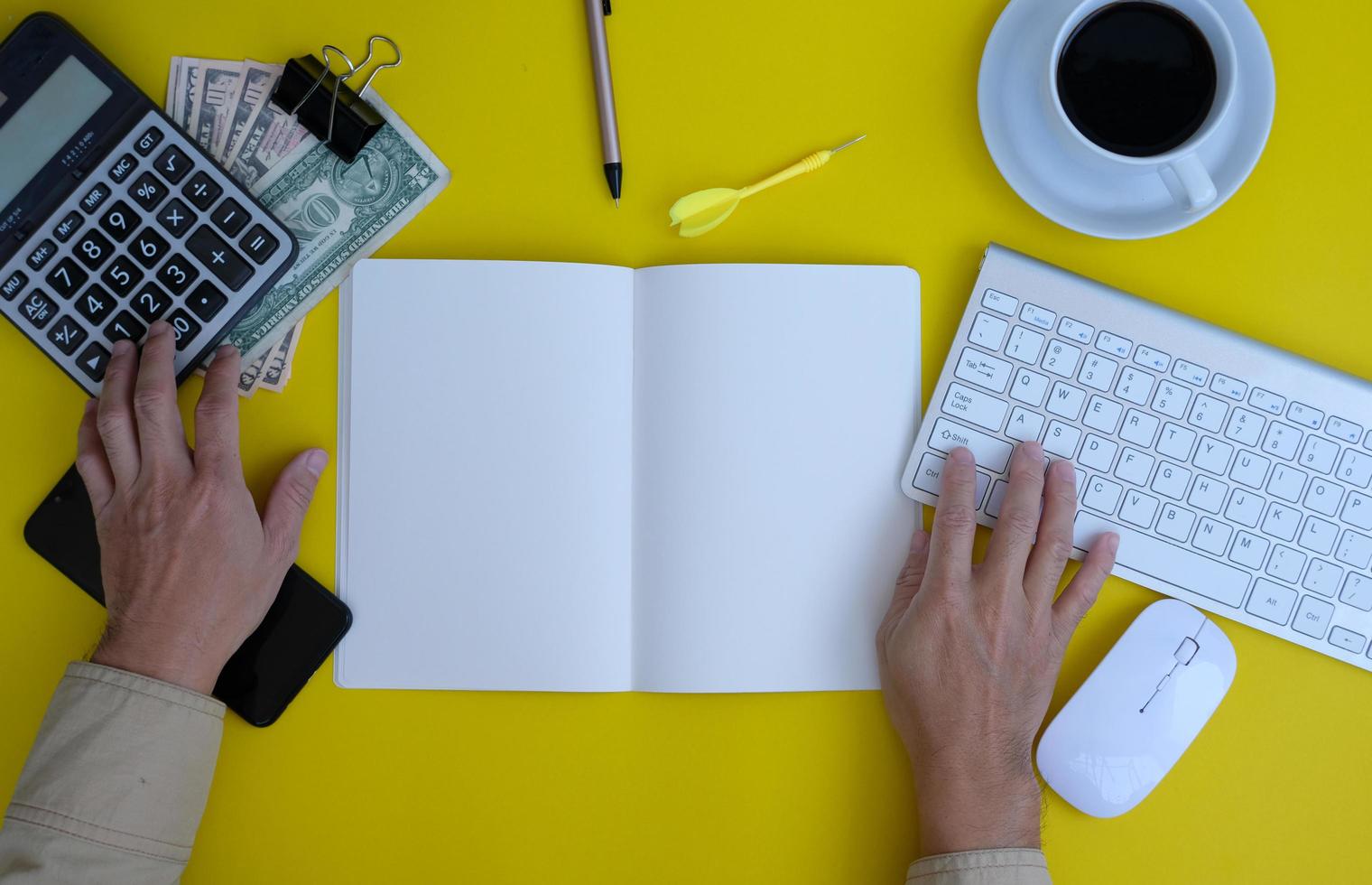 Top view of a businessman working on a desk in an office and the new regular working environment photo