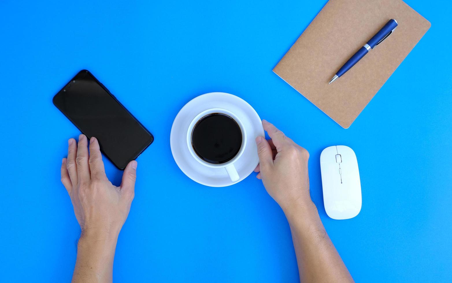 Hands of a man working on a modern laptop Banking and money themes on a blue background in an office. photo