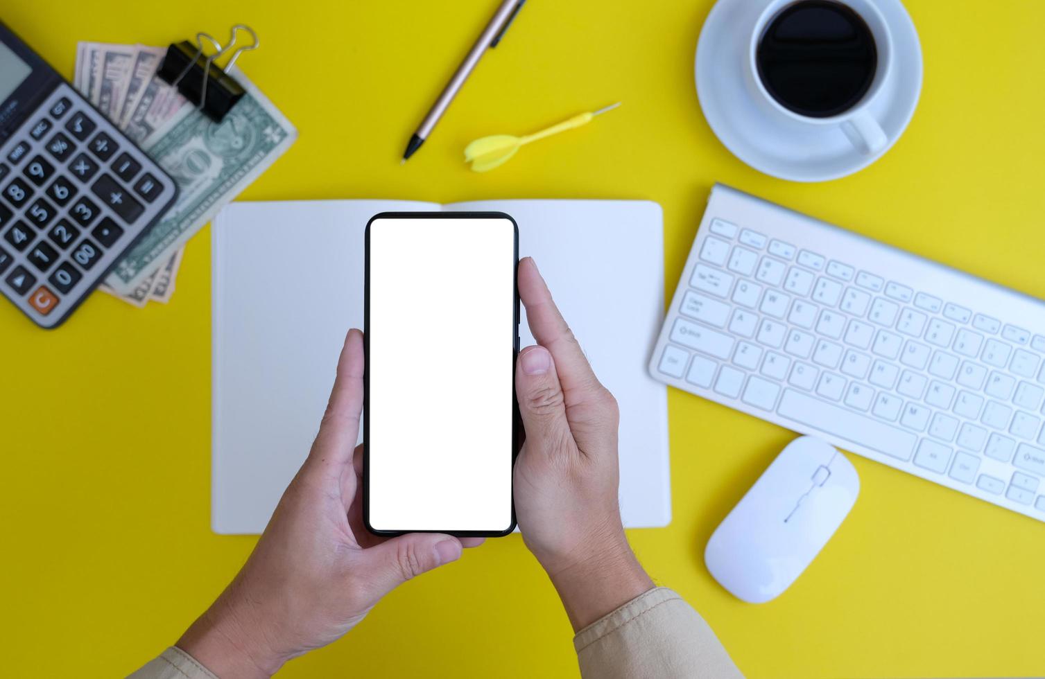 Top view of a businessman working on a desk in an office and the new regular working environment photo