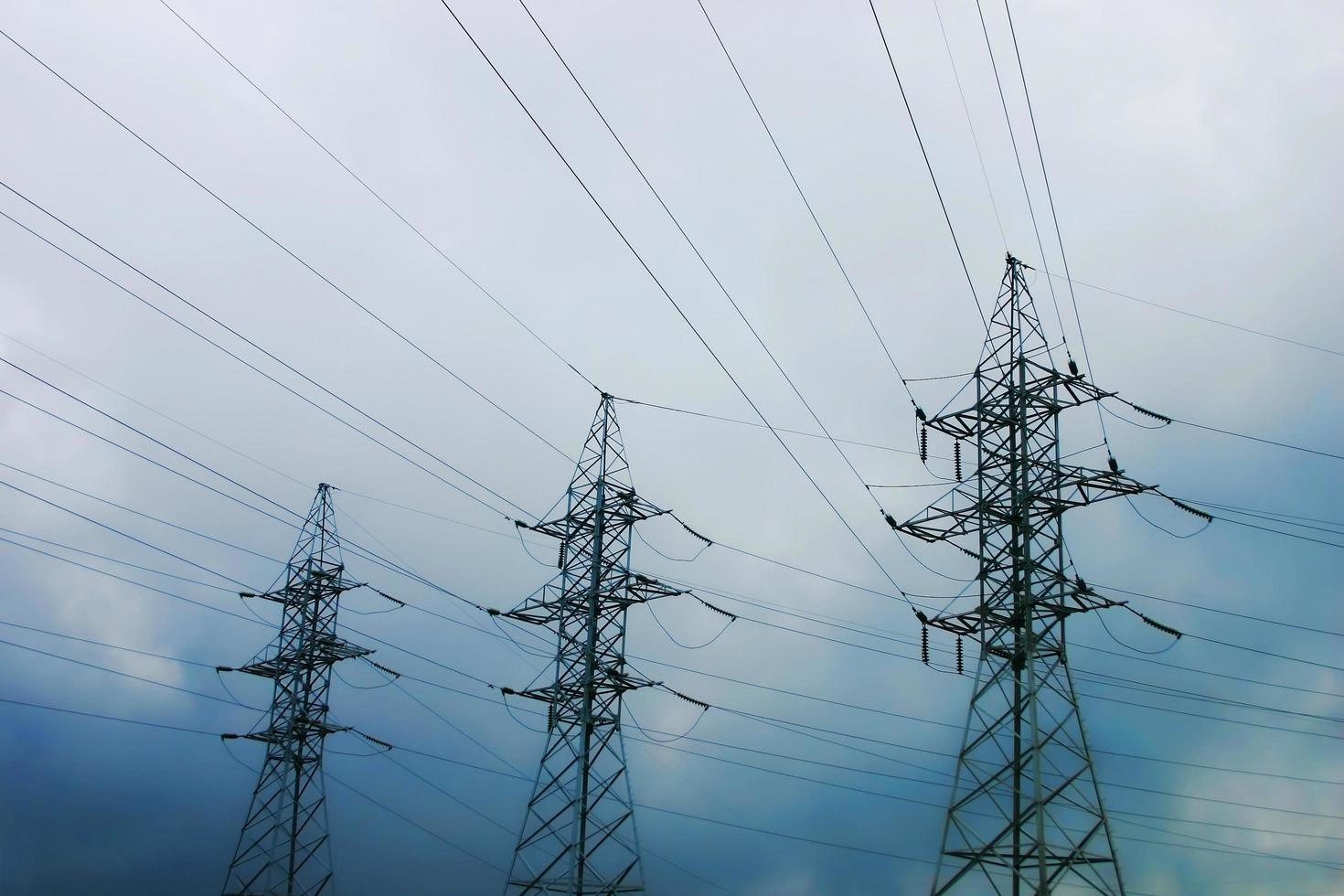 High power lines against clear blue sky photo