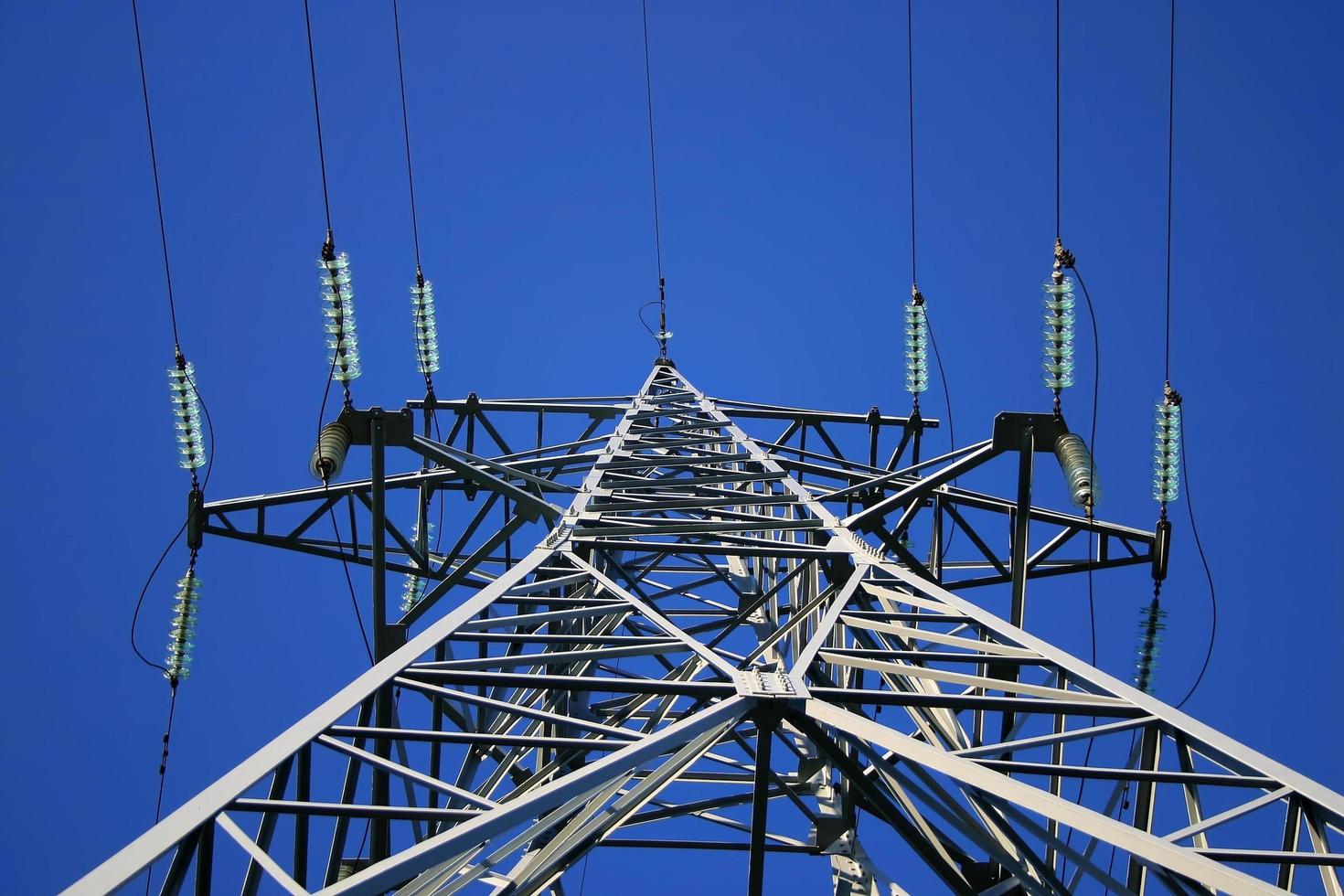 High power lines against clear blue sky photo