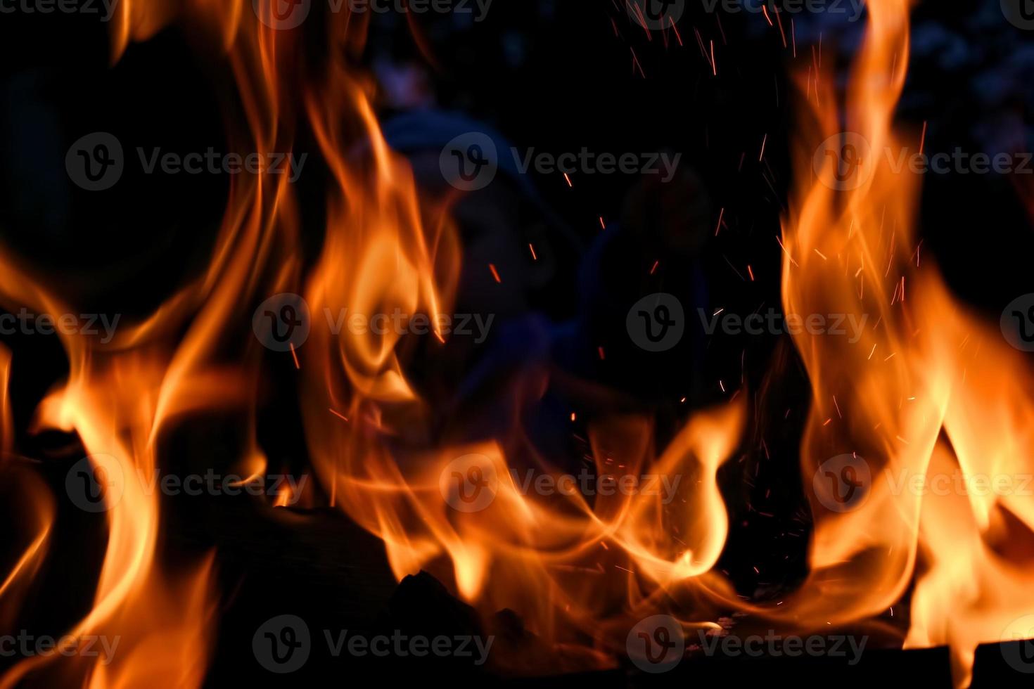 Fire background against dark night photo