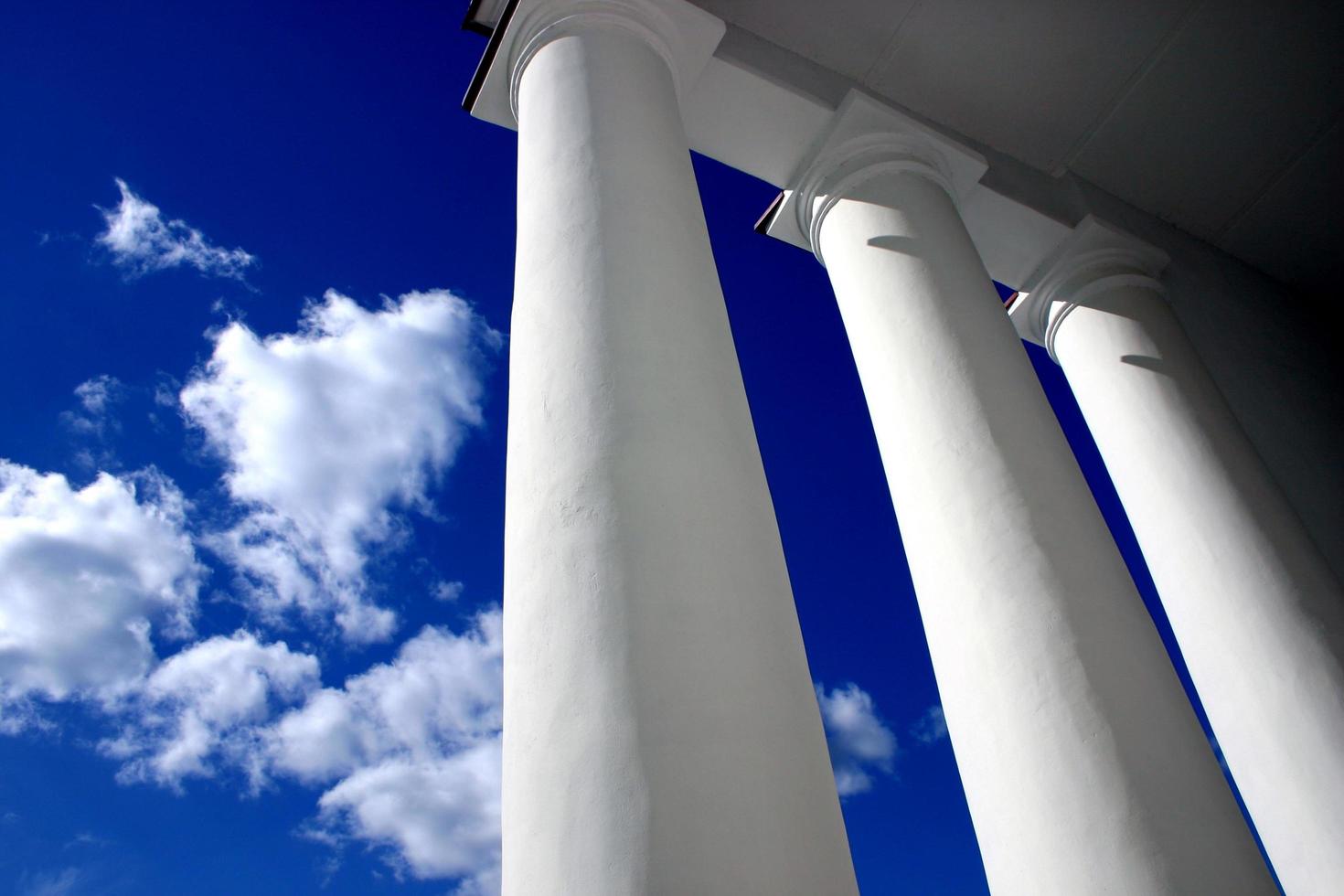 White columns against clear blue sky photo