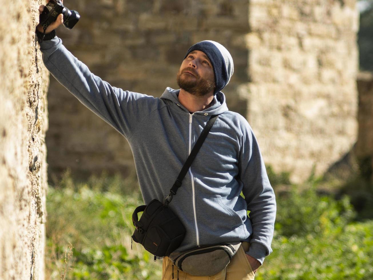 man stands against a wall in a fortress photo