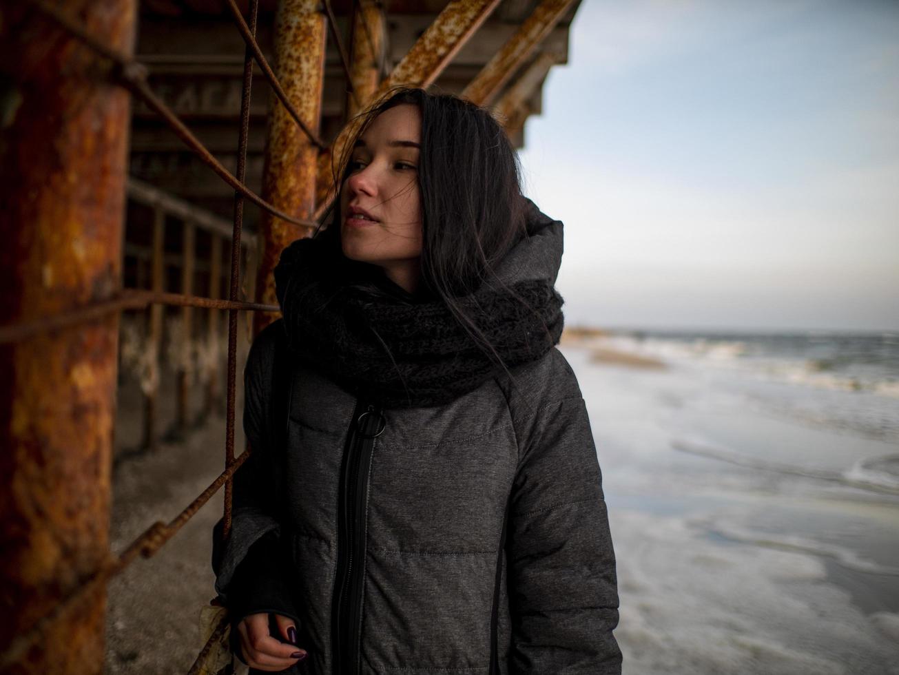 young girl in a coat stands photo