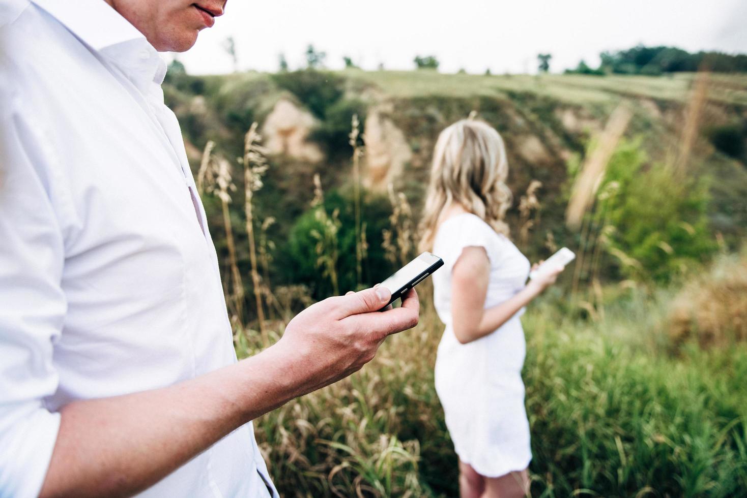 a guy with a girl in light clothes on the background of a green canyon photo