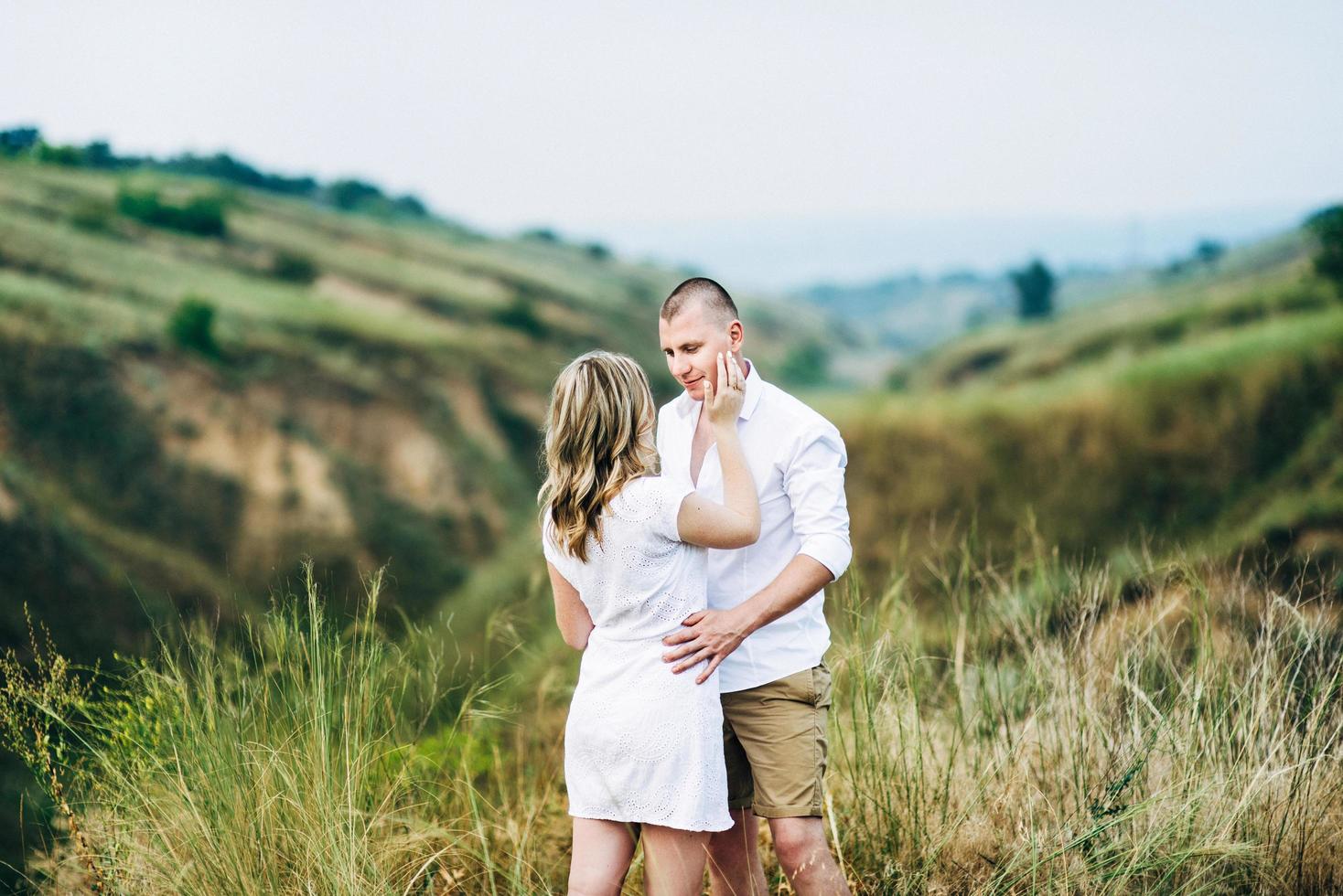 a guy with a girl in light clothes on the background of a green canyon photo