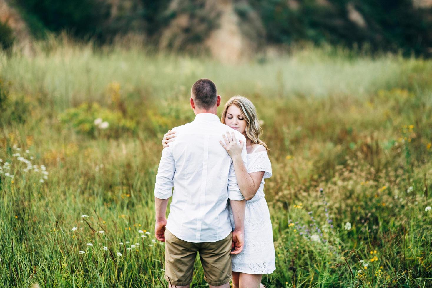 a guy with a girl in light clothes on the background of a green canyon photo
