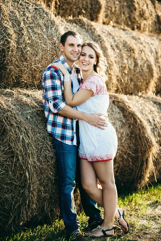 a guy with a girl on a summer walk in the field photo
