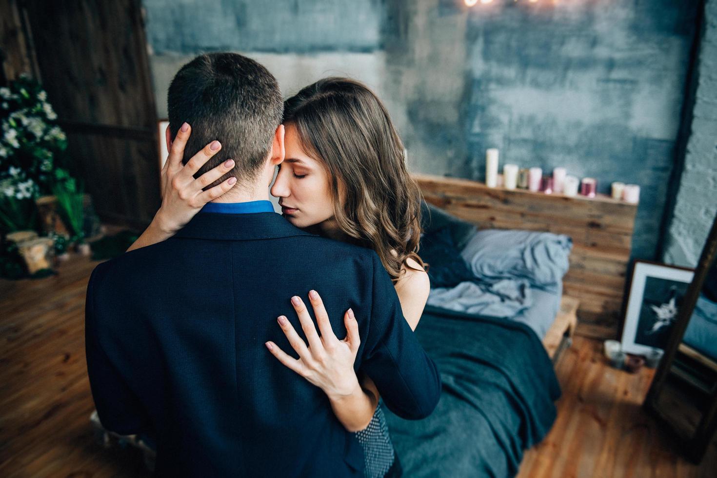 a guy and a girl hug each other, standing in the bed photo