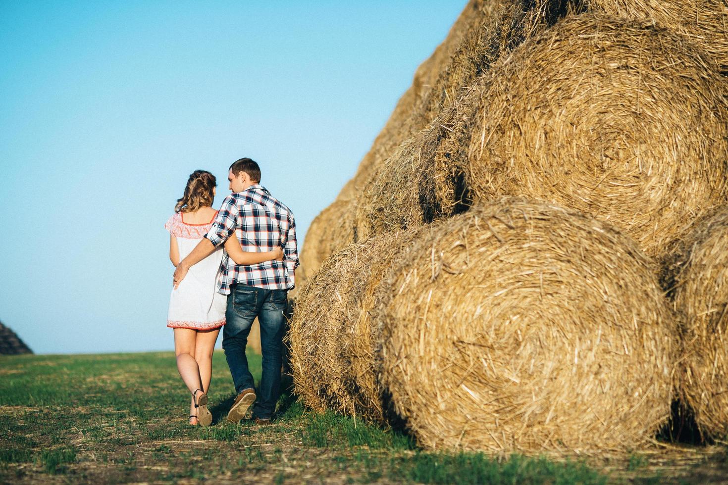 a guy with a girl on a summer walk in the field photo