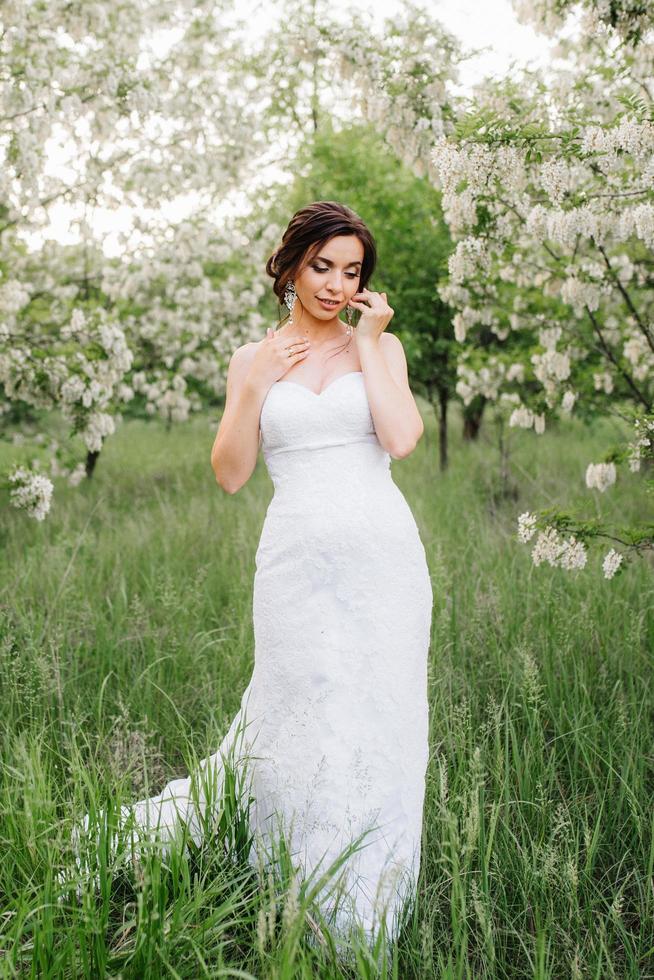 bride in a white dress with a large spring bouquet photo