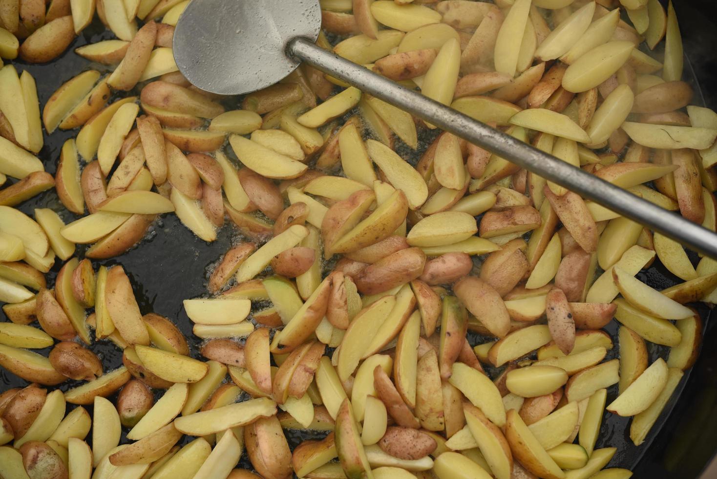 fried potatoes in a huge wok photo