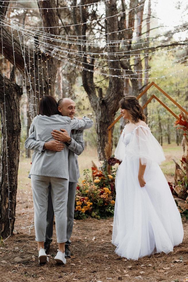 man and woman got engaged in autumn forest photo