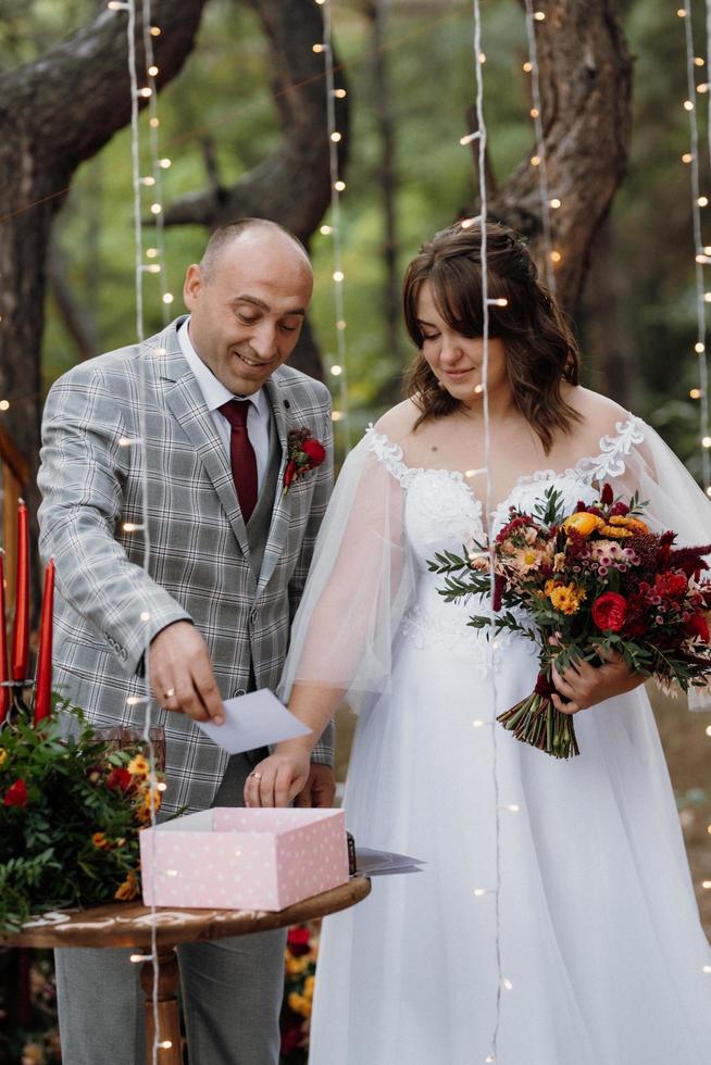 man and woman got engaged in autumn forest photo