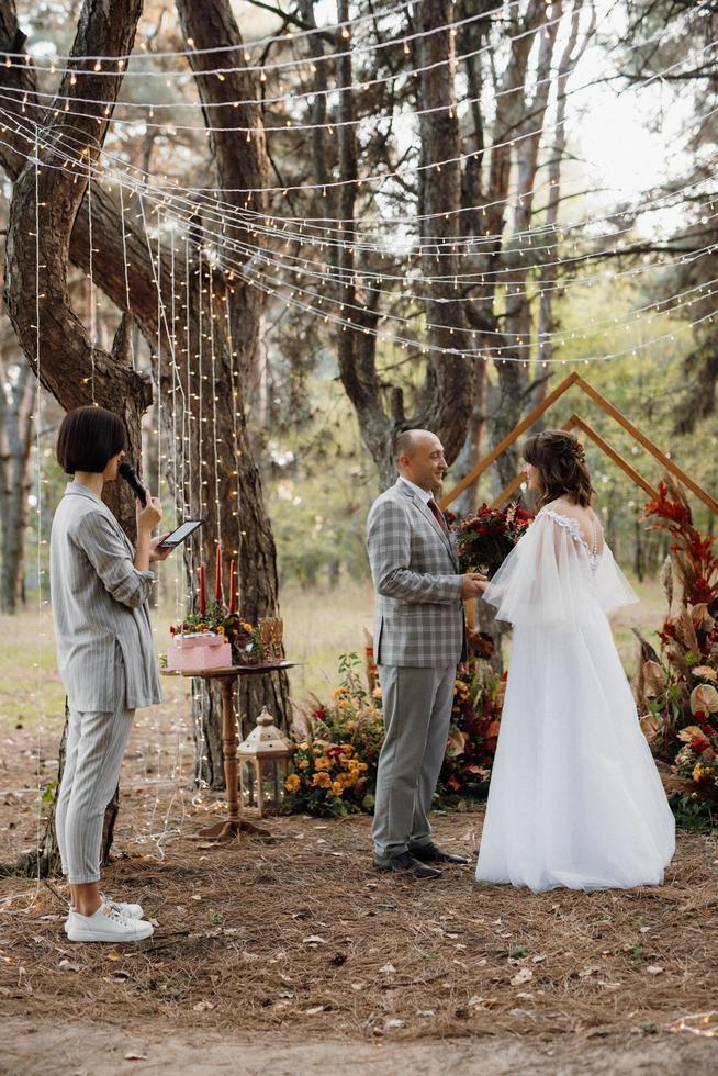 man and woman got engaged in autumn forest photo