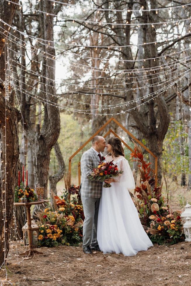 man and woman got engaged in autumn forest photo