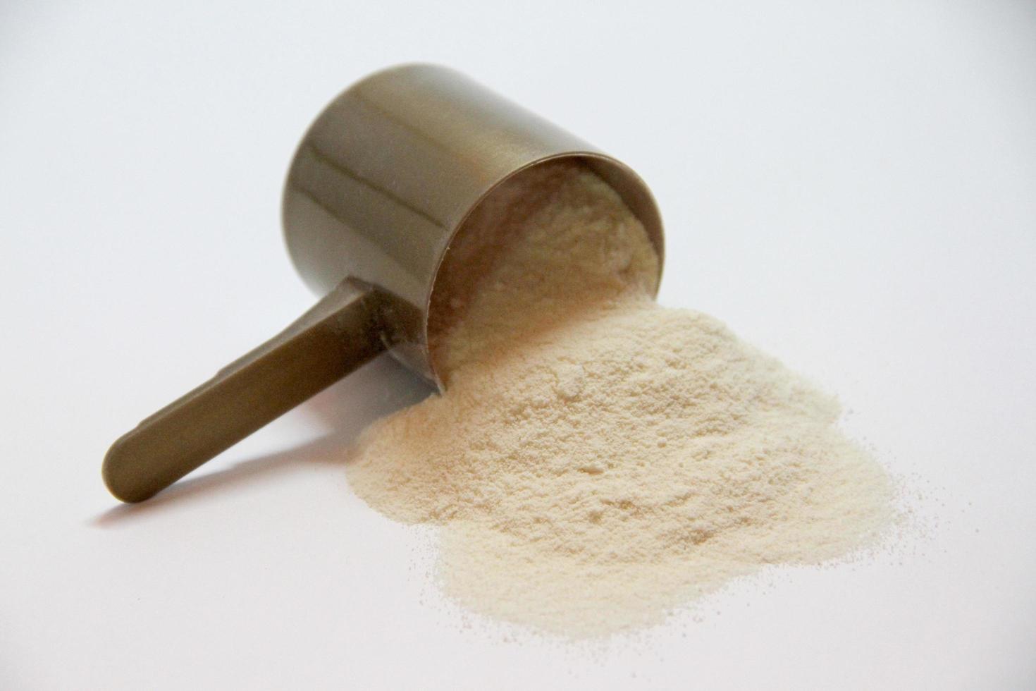 Brown scoop with beige fine grained powder photo