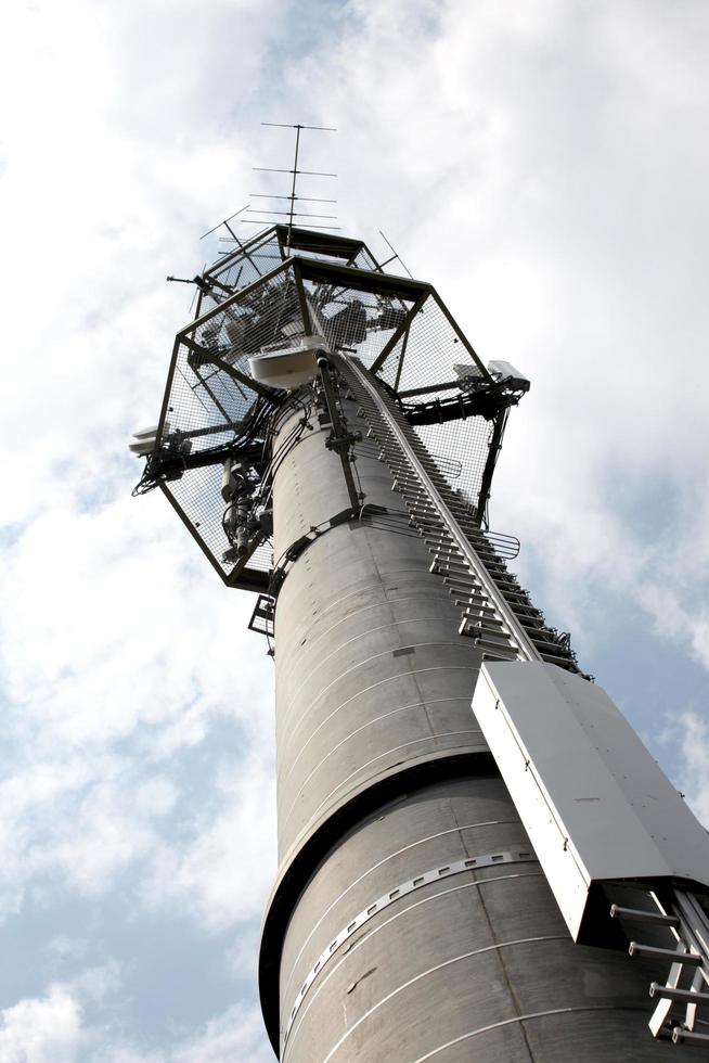 High telecommunication tower on blue sky background photo