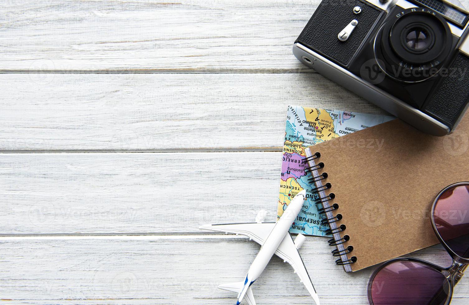 Traveler accessories on wooden  background photo