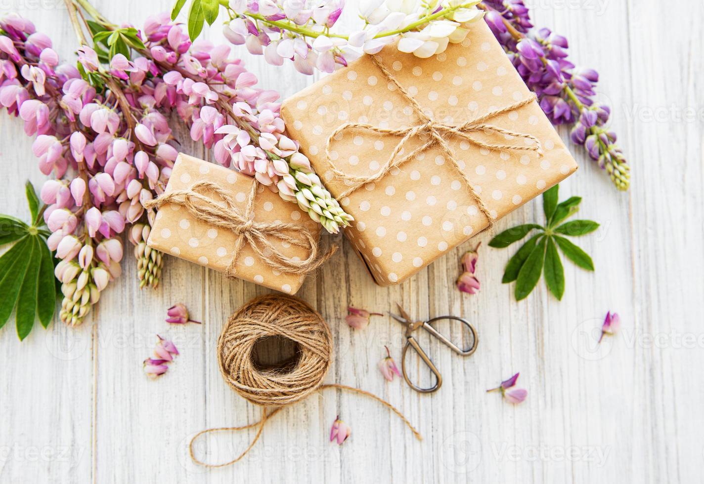 Lupine flowers and gift boxes photo