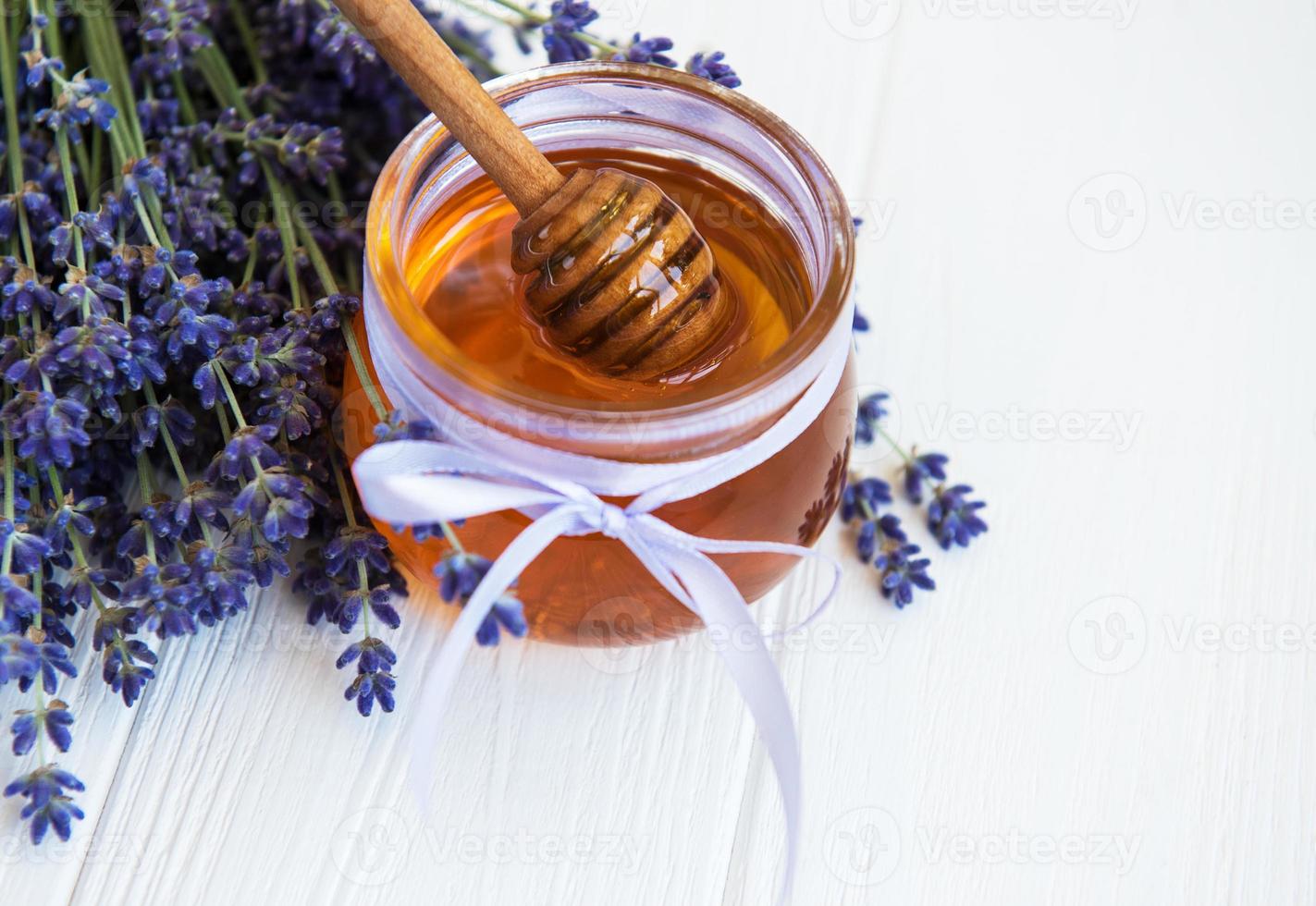 Jar with honey and fresh lavender flowers photo