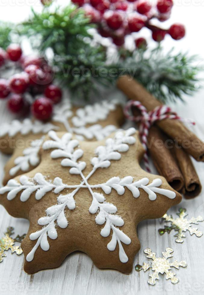 Christmas gingerbread with christmas decorations on white wooden photo