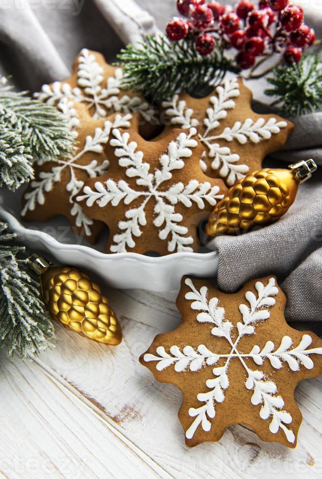 Bowl of gingerbread Christmas cookies on rustic white wooden table photo