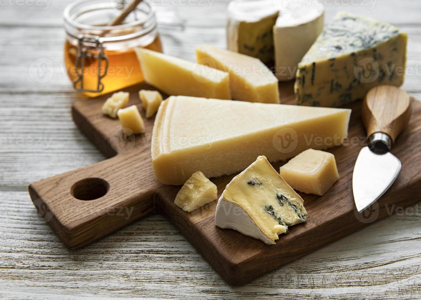 Various types of cheese  on a white wooden  background photo