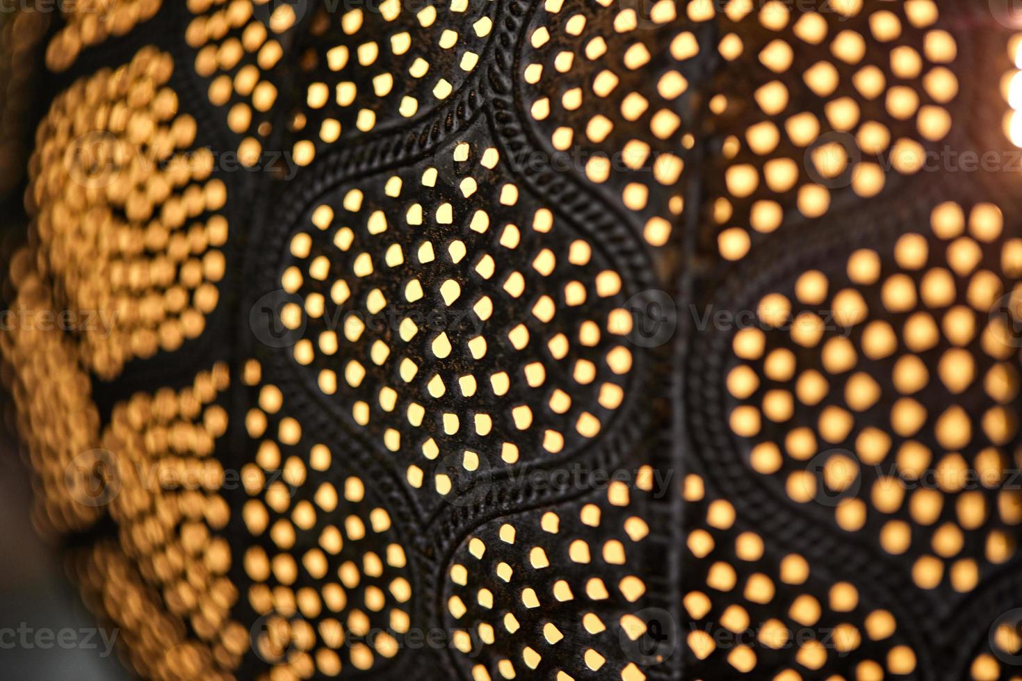 Ceiling lamp in dark colors with light dots, texture photo