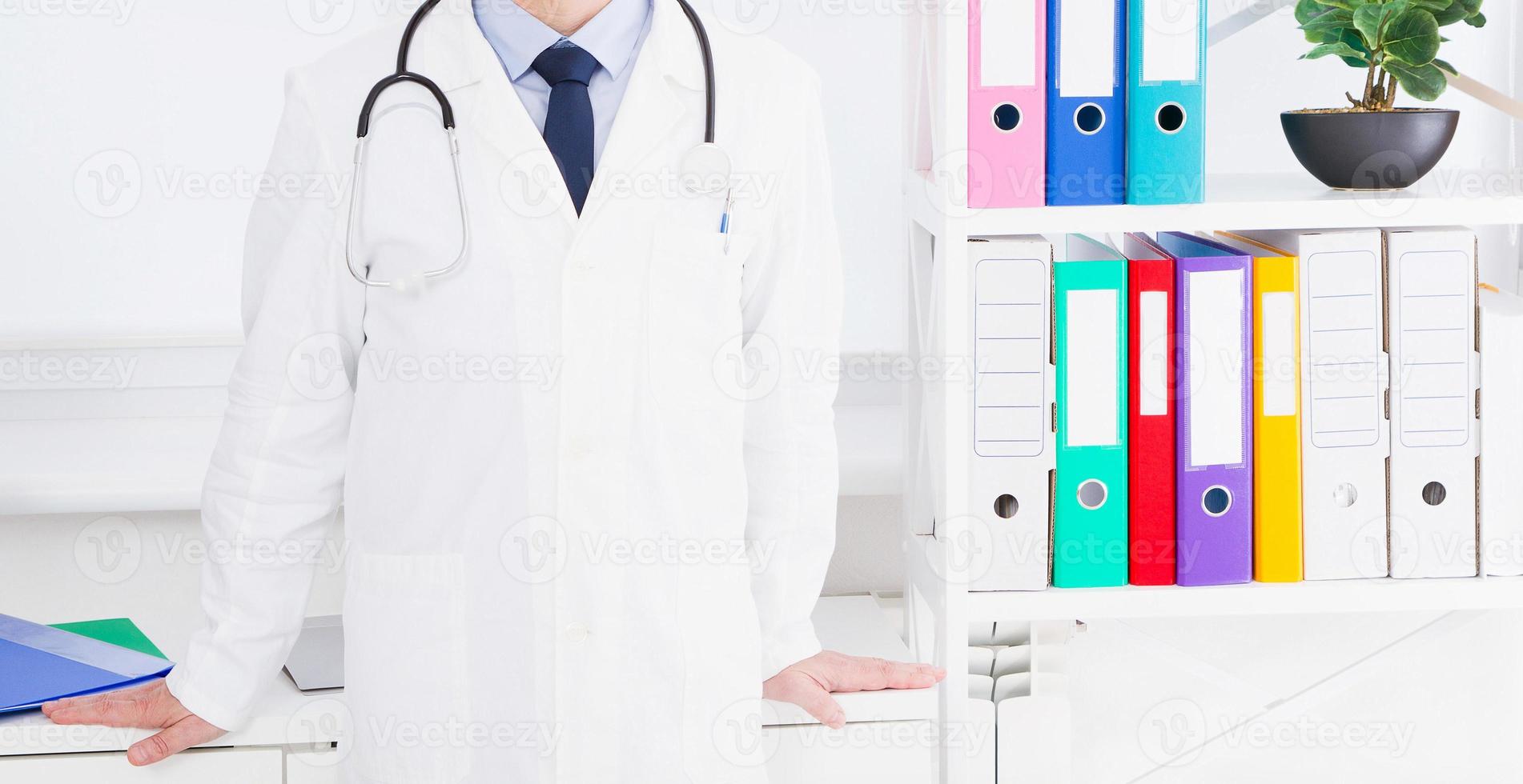 Portrait of senior doctor in medical office photo