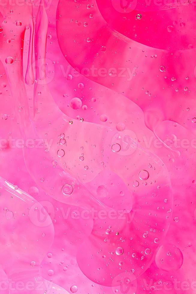 Photo of oil on a water surface with bubbles.soft pink. Abstract colorful background.