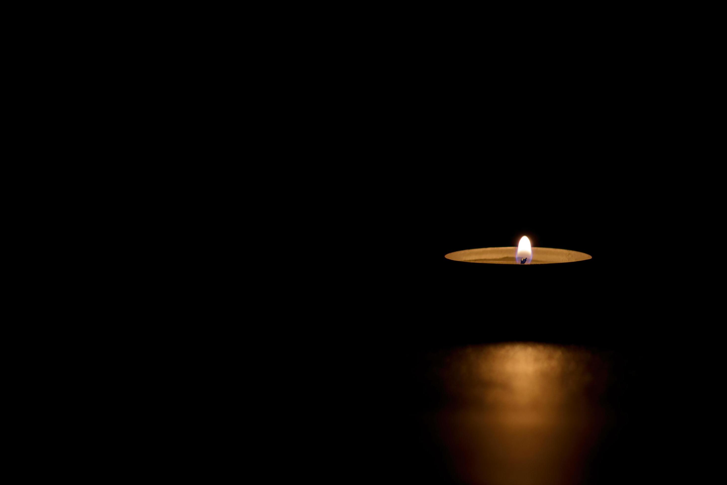 Candle lighting the dark. Darkness, Memorial, Hope. 4744882 Stock Photo