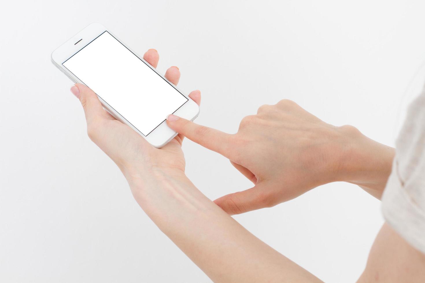 Hand holding white phone isolated on white clipping path inside. Top view.Mock up.Copy space.Template.Blank. photo