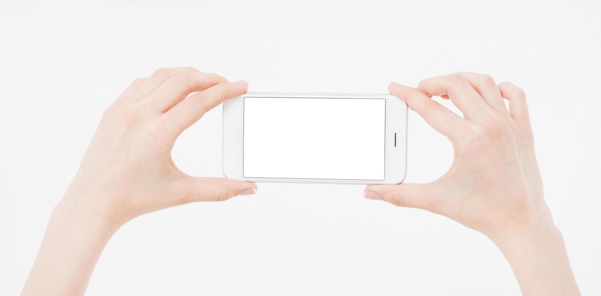 Hand holding white cellphone isolated on white clipping path inside. Online shopping. Top view. Mock up. Copy space. Template.Blank. photo