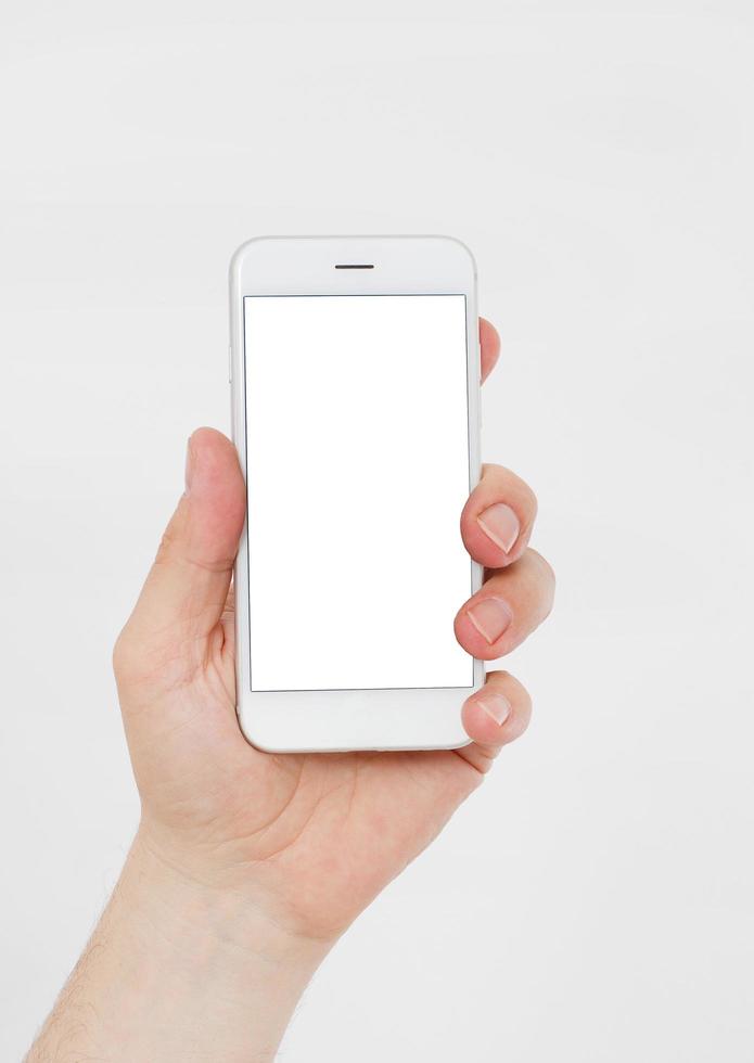 Hand holding white cellphone isolated on white clipping path inside. Online shopping. Top view. Mock up. Copy space. Template.Blank. photo