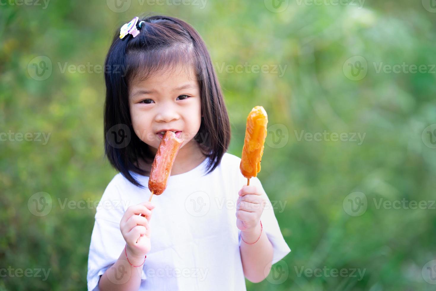 Child are hungry. Kid happily ate sausage skewers. Copy space. photo