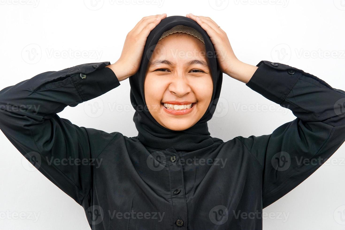 Closeup of beautiful young Muslim woman holding head isolated photo