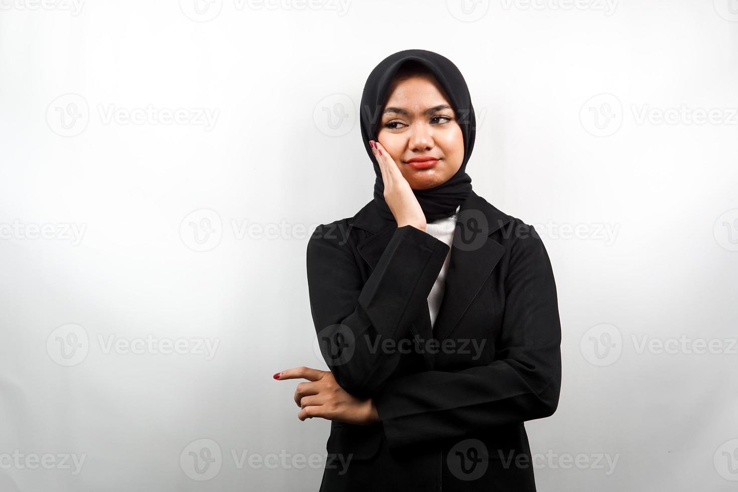 Beautiful asian young muslim business woman thinking, looking for ideas, looking for solutions to problems, with hands holding cheeks, isolated on white background photo