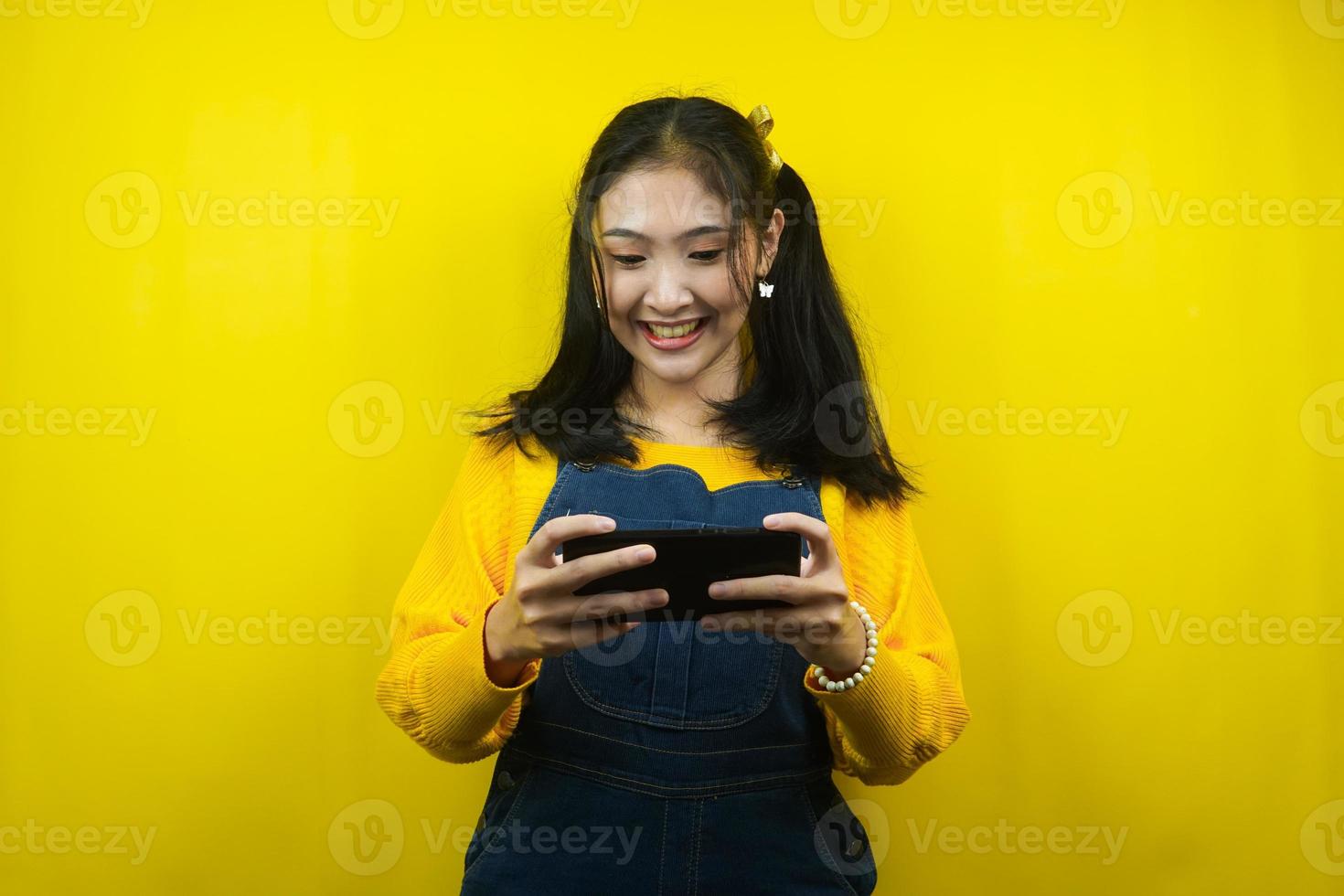 Pretty and cute young woman cheerful, playing game, promoting something, advertisement, isolated photo
