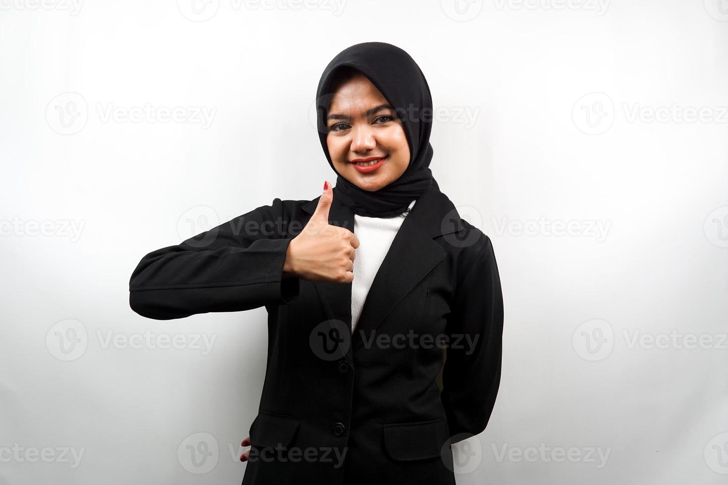 Beautiful young asian muslim business woman with hands thumbs up, ok sign, good job, success, victory, smiling confident, enthusiastic and cheerful, looking at camera isolated on white background photo