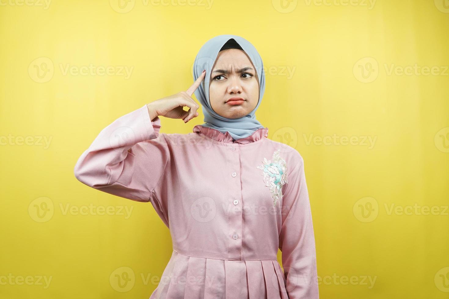 Beautiful young muslim woman thinking, confused, isolated photo