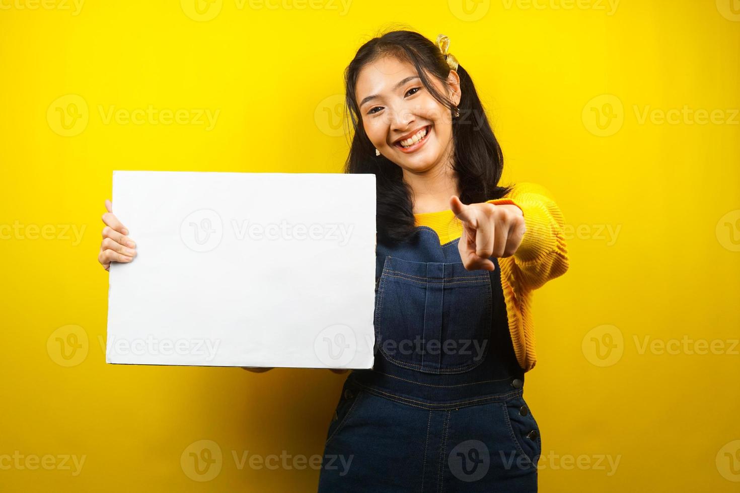 Pretty and cute young woman cheerful holding blank empty banner, placard, white board, blank sign board, white advertisement board, presenting something in copy space, promotion photo