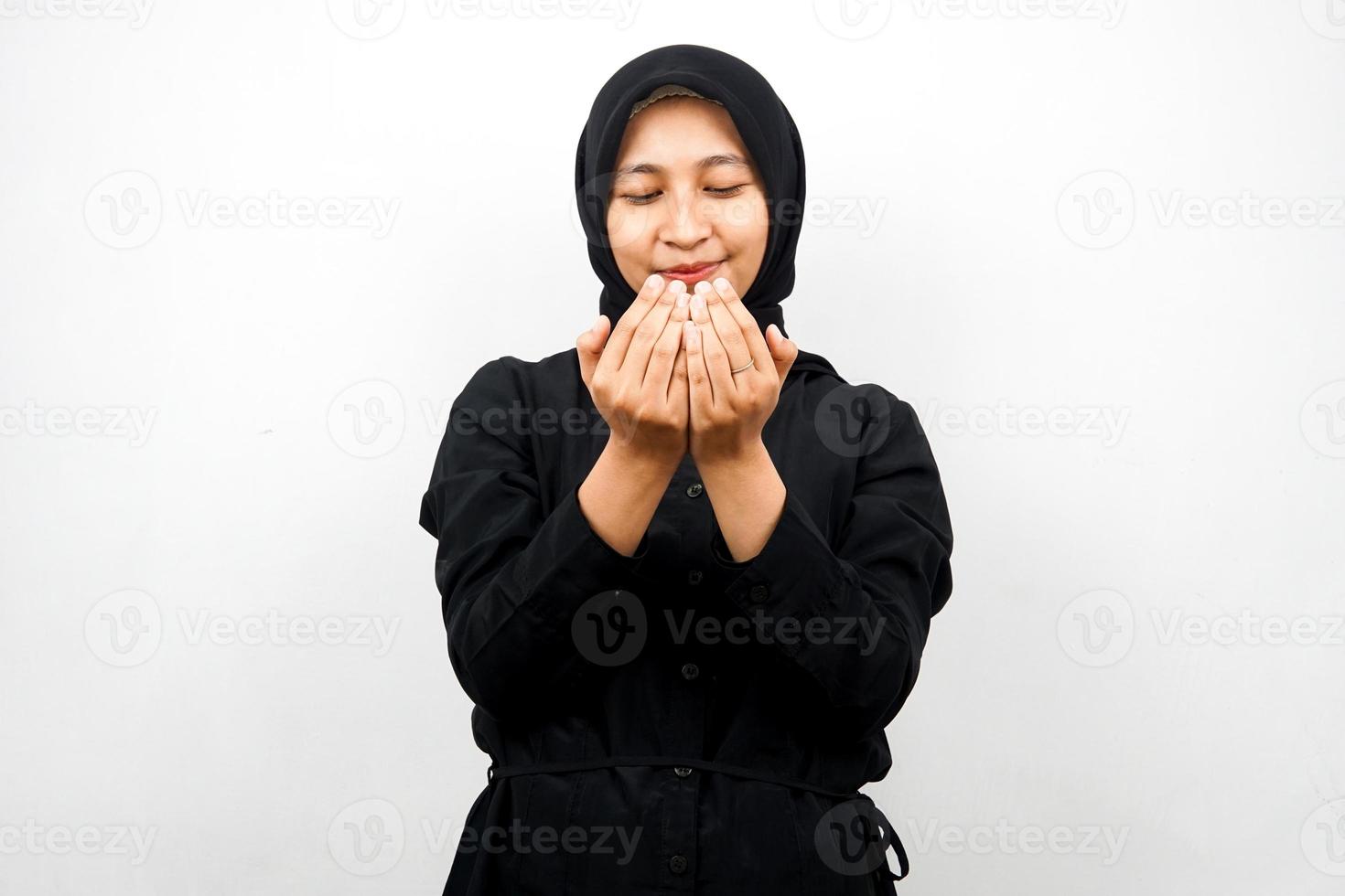 Beautiful young asian muslim woman praying, with open arms, isolated on white background photo