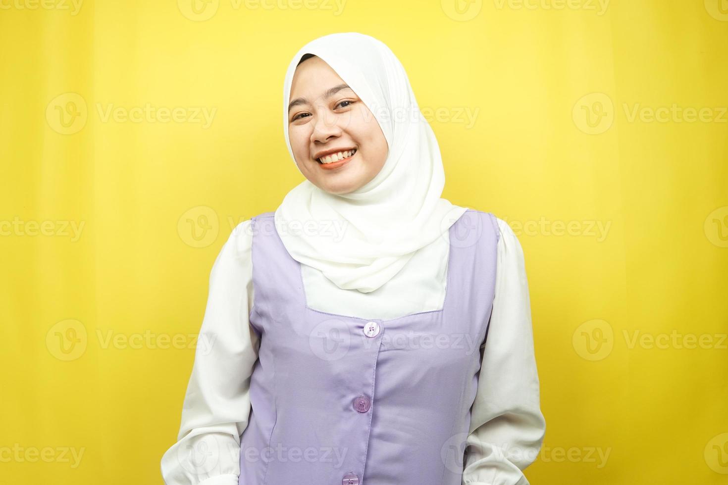 Hermosa joven mujer musulmana asiática sonriendo con confianza, frente a la cámara aislada sobre fondo amarillo foto