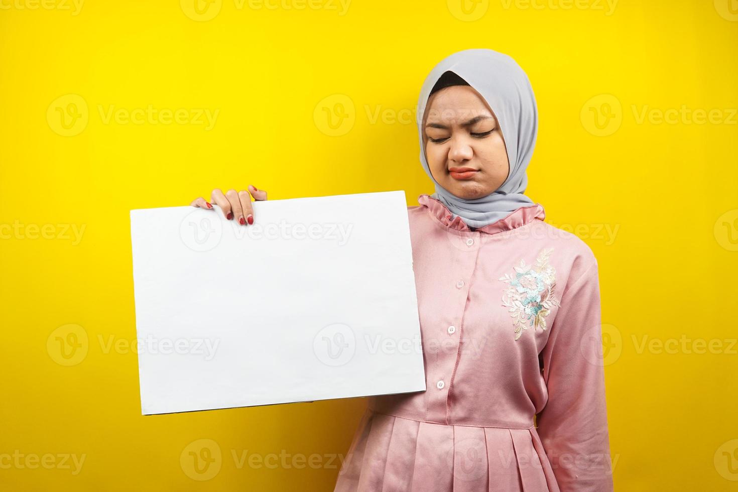 Pretty young muslim woman sad, hand holding blank empty banner, placard, white board, blank sign board, white advertisement board, presenting something in copy space, promotion photo