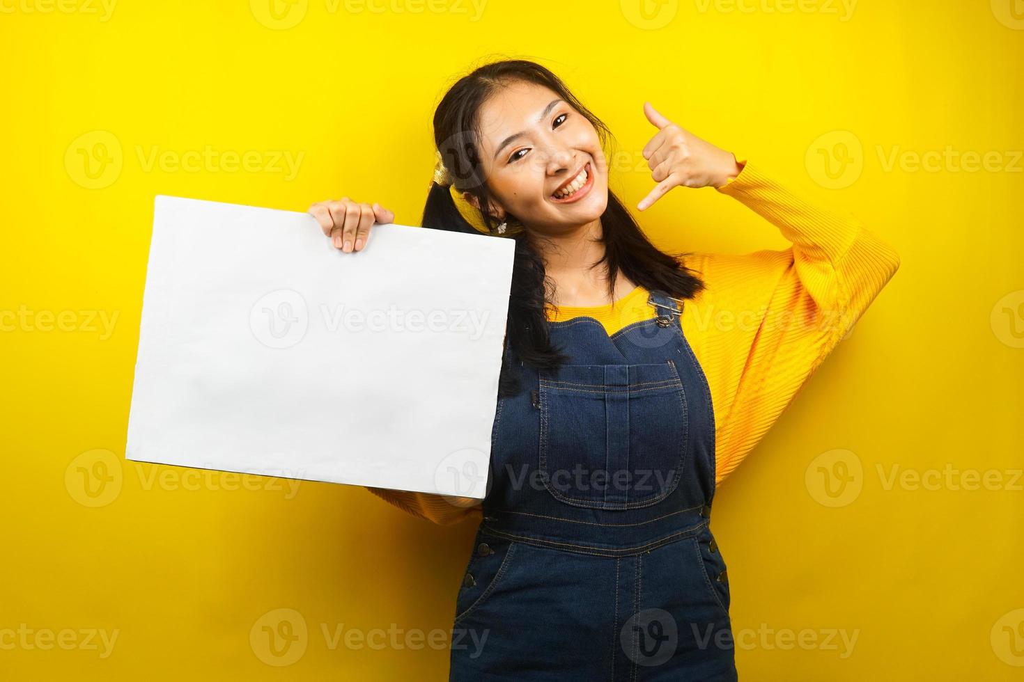 Pretty and cute young woman cheerful holding blank empty banner, placard, white board, blank sign board, white advertisement board, presenting something in copy space, promotion photo