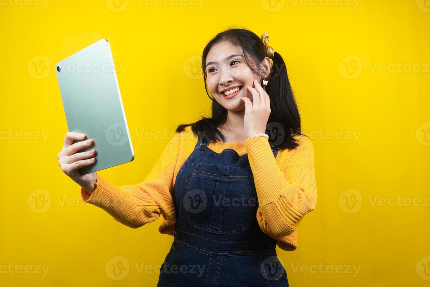 Pretty and cute young woman cheerful, confident, hand holding tablet, presenting something, promoting product, advertisement, isolated photo